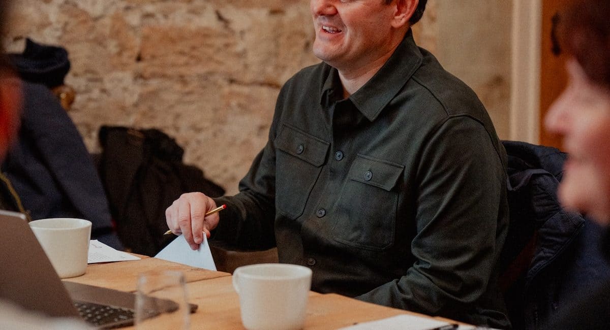 Simon Laing - male trainer sat at table